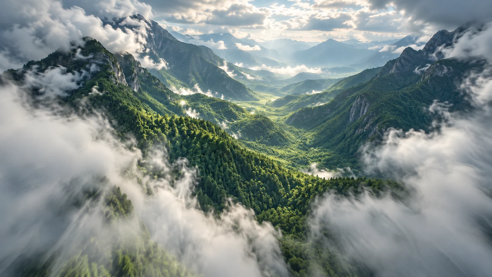 Clouds opening over a sunlit green mountain valley